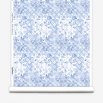 Wallpaper roll with blue and white watercolor floral pattern on a white background.