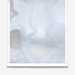 Mural wallpaper roll in an abstract textural watercolor design in pale grey blue. 