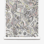 Wallpaper roll in abstract brushstroke design in shades of grey, tan and blush accents. 