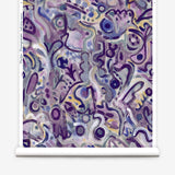 Wallpaper roll in abstract brushstroke design in shades of purple and black accents. 
