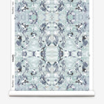 Wallpaper roll in a watercolor paint blotch print in blue, gray and purple on a white field.
