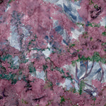 Detail of wallpaper in a painterly tree print in purple, green and brown.