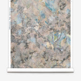 Wallpapper roll in a painterly tree print in cream, gray and turquoise.