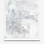 Wallpaper roll mural in a minimal splatter print in shades of gray on a cream field.