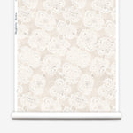 Wallpaper roll with beige watercolor lace floral pattern on a white background.
