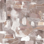 Wallpaper detail in a textural paint blotch print in shades of brown and tan on a white field.