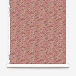 Wallpaper roll in an undulating abstract watercolor motif in pink, orange and grey. 