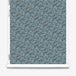 Wallpaper roll in an undulating abstract watercolor motif in shades of steel blue and charcoal. 