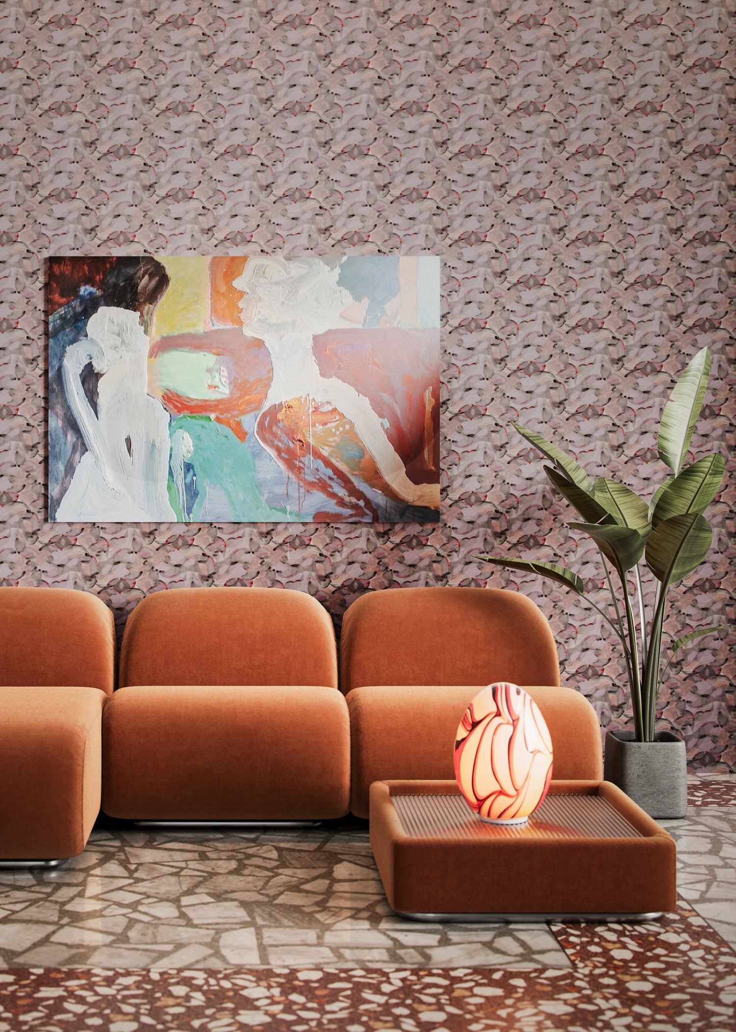 Living room scene with orange retro furniture, potted plant and abstract painting against wallpaper in an undulating abstract watercolor motif in light purple, blush, rust and charcoal.