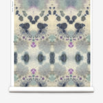 Wallpaper roll in a watercolor inkblot print in shades of blue and purple on a cream field.