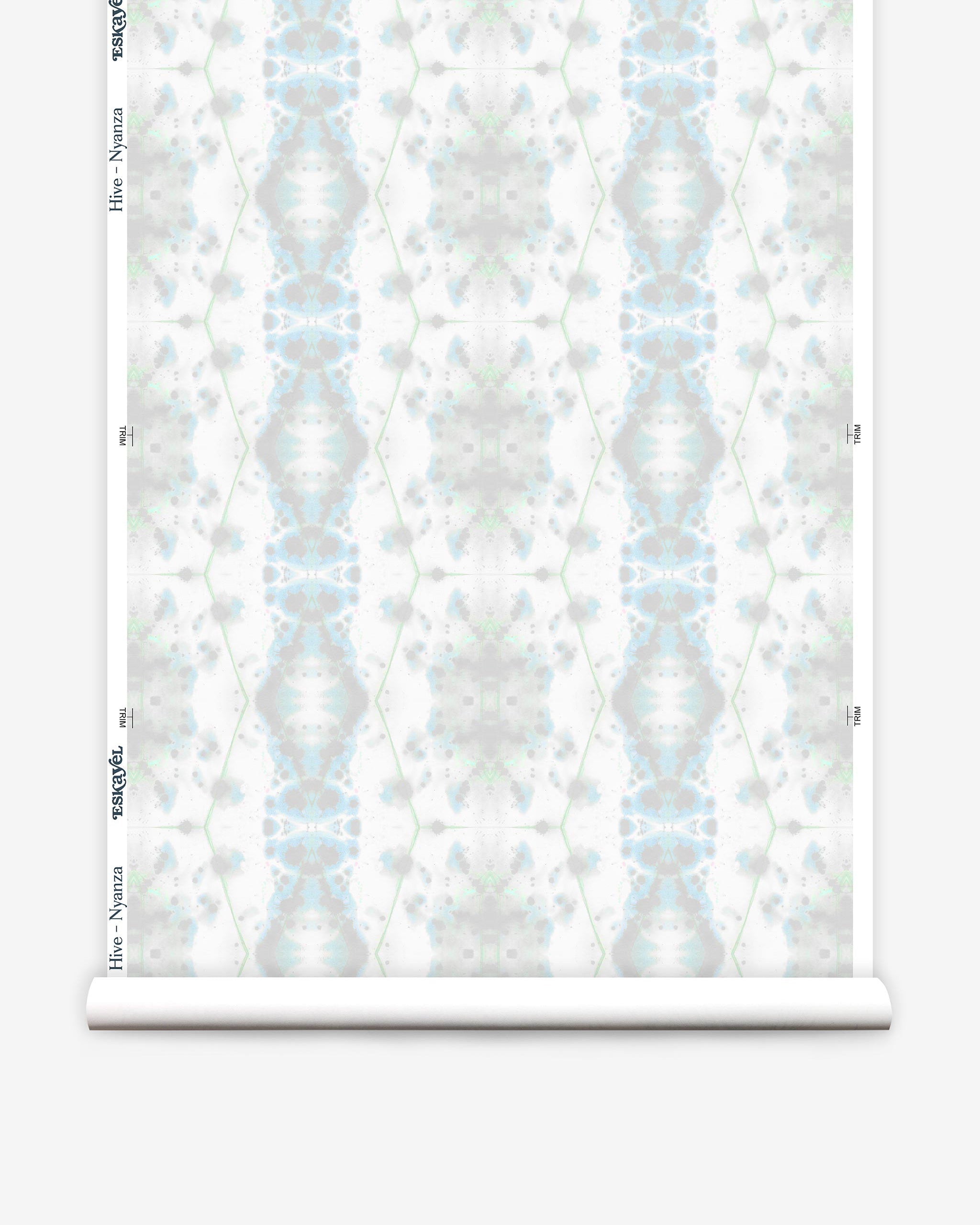 Partially unrolled wallpaper yardage in a painterly gometric stripe in gray, blue and green on a white field.