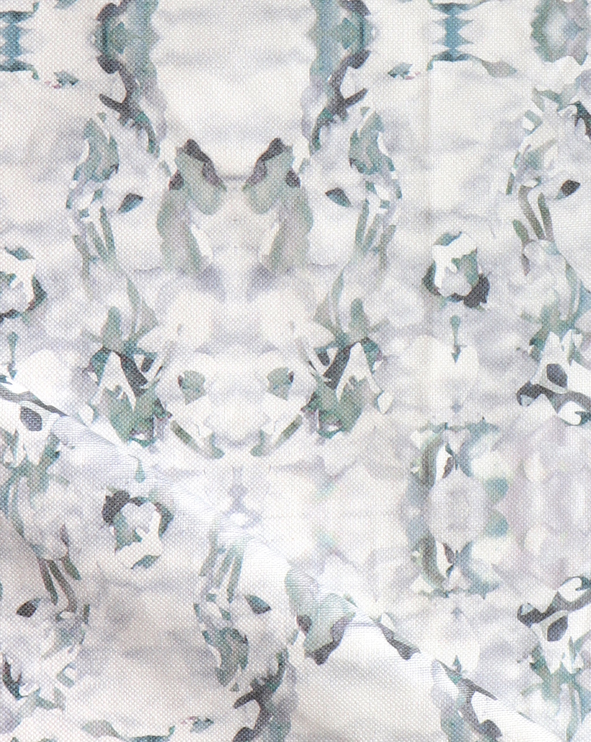 Detail of fabric in a watercolor paint blotch print in gray and turquoise on a white field.