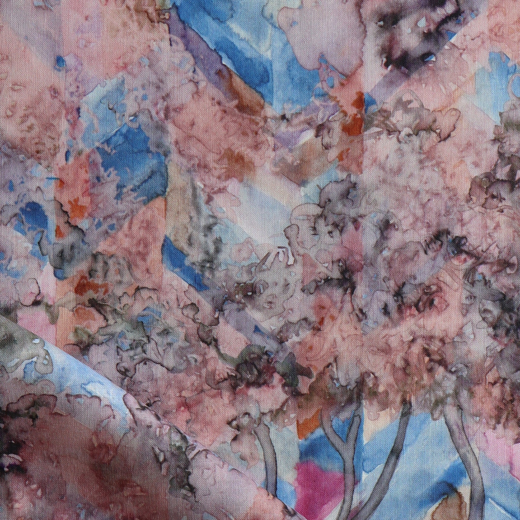 Detail of fabric in a painterly tree print in pink, orange, gray and blue.