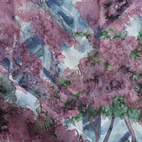 Detail of fabric in a painterly tree print in purple, green and brown.