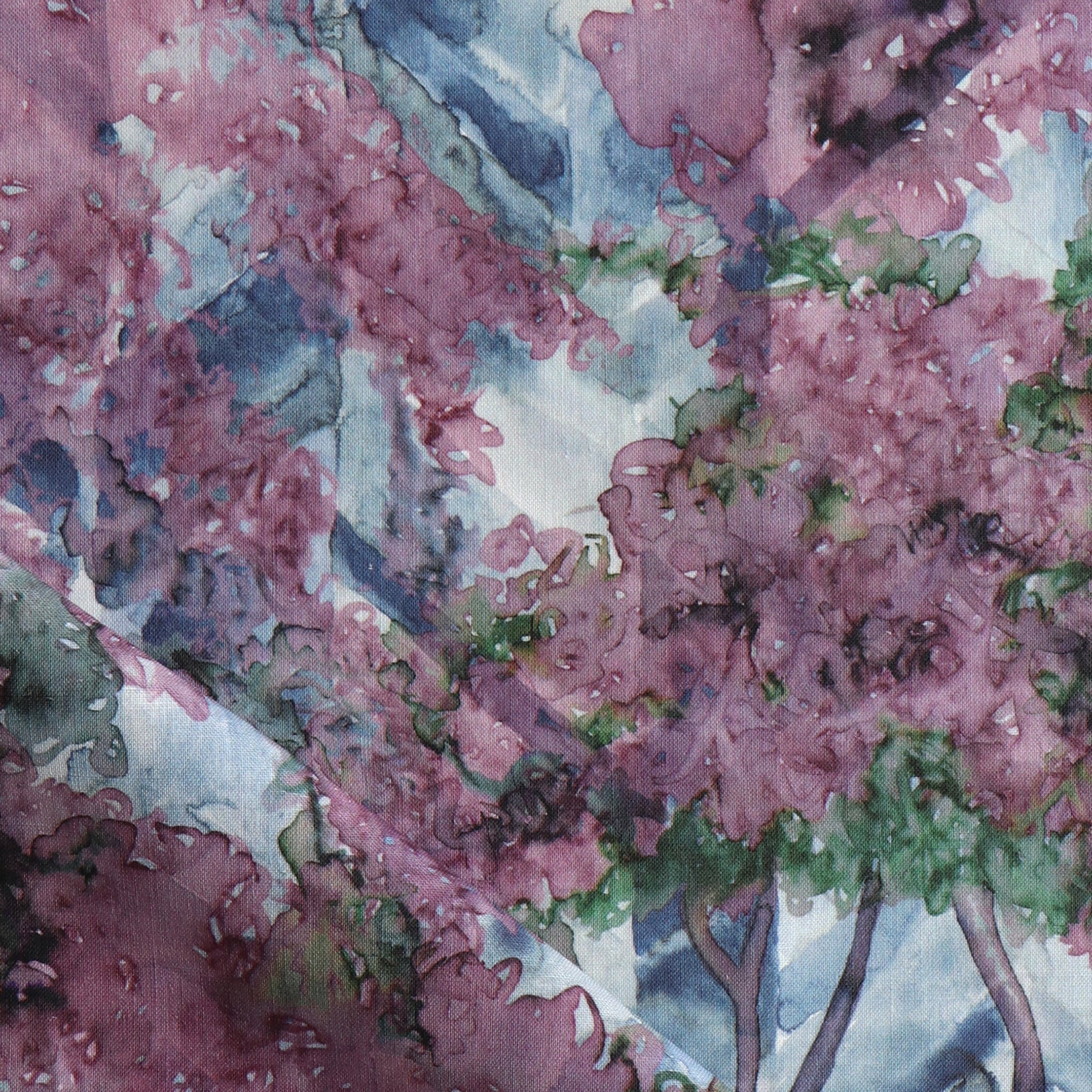 Detail of fabric in a painterly tree print in purple, green and brown.