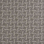 Detail of fabric in a geometric grid pattern in black on a cream field.