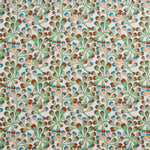 Detail of fabric in an abstract botanical print in green, red and tan on a white field.