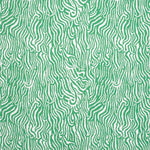 Detail of fabric in a playful animal print in light green on a white field.