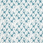 Detail of fabric in a playful abstract shape print in white on a turquoise field.