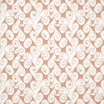 Detail of fabric in a playful abstract shape print in white on a peach field.