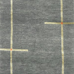Handknotted carpet in a contempoary linear design in taupe with orange accents on a grey field. 