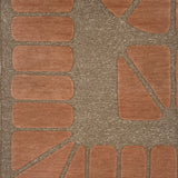 Handknotted carpet in a raised geometric design in peach on a taupe field.