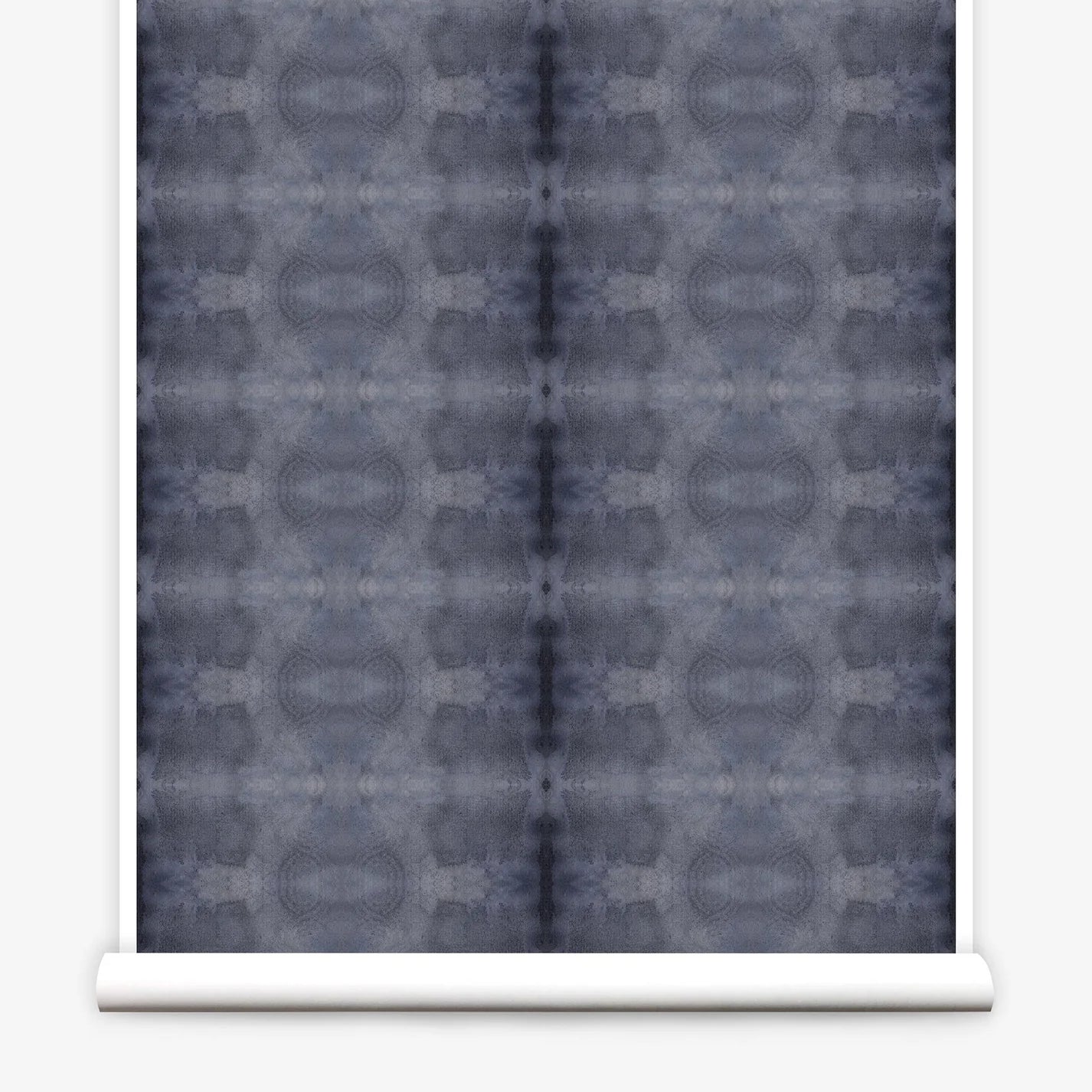 Partially unrolled wallpaper yardage in a repeating ink blot print in navy on a charcoal field.