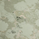 Detail of wallpaper in a dense photorealistic floral print in shades of gray and pastel green.