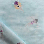 Fabric with watercolor characters swimming on a light blue background