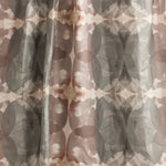 Draped fabric yardage in a cloudy ink blot print in shades of gray and pink on a cream field.