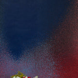 Two vases of flowers stand in front of a wall covered in an abstract ombré paint splatter print in red, blue and black.