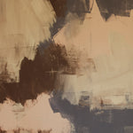 Detail of wallpaper in an abstract paint print in shades of tan, gray and brown.