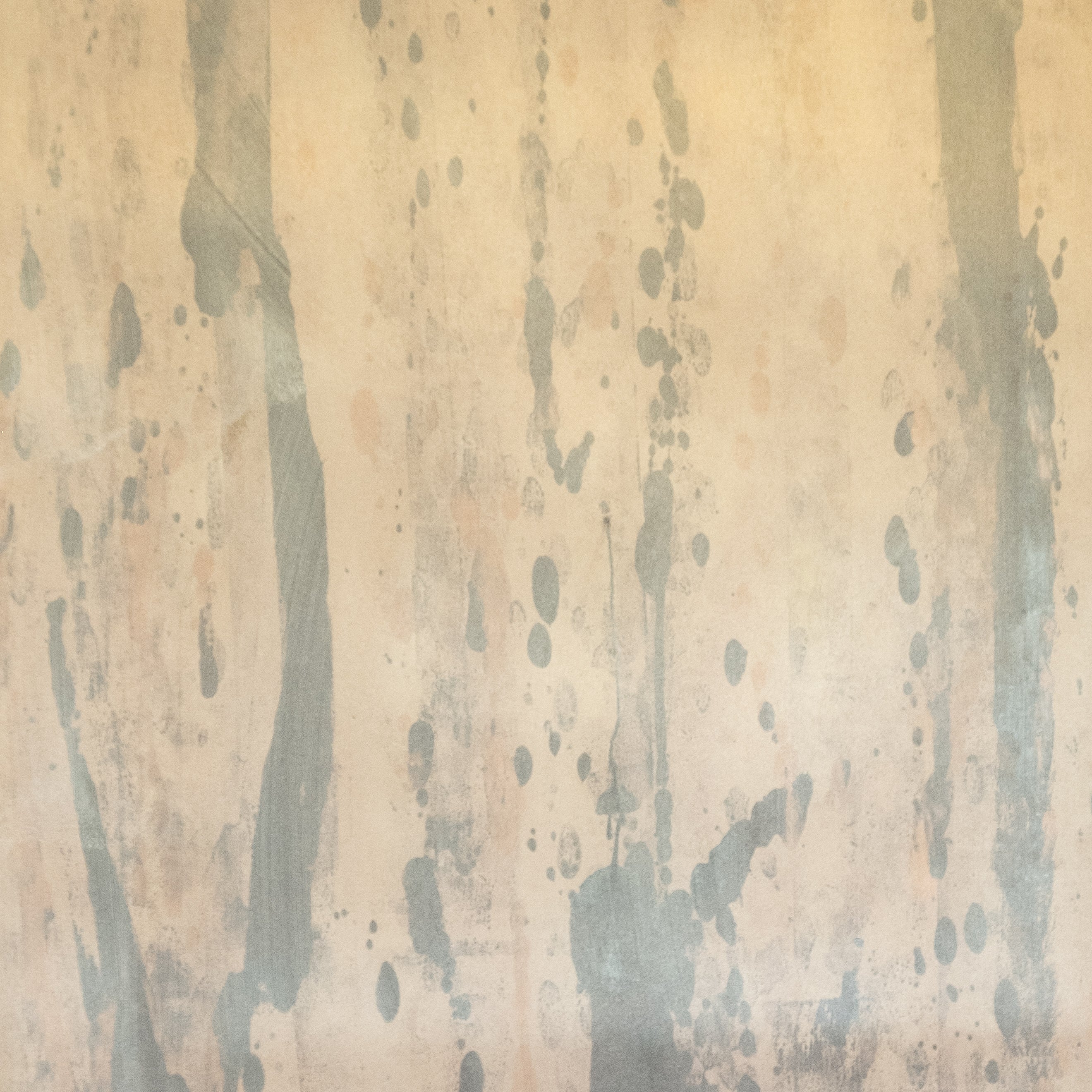Detail of wallpaper in a textural paint splatter print in shades of gray and tan.