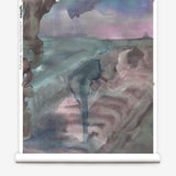 Partially unrolled wallpaper yardage in a watercolor painterly print in shades of pink, turquoise and gray.