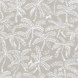 Detail of fabric in a playful palm tree and monkey print in white on a light gray field.