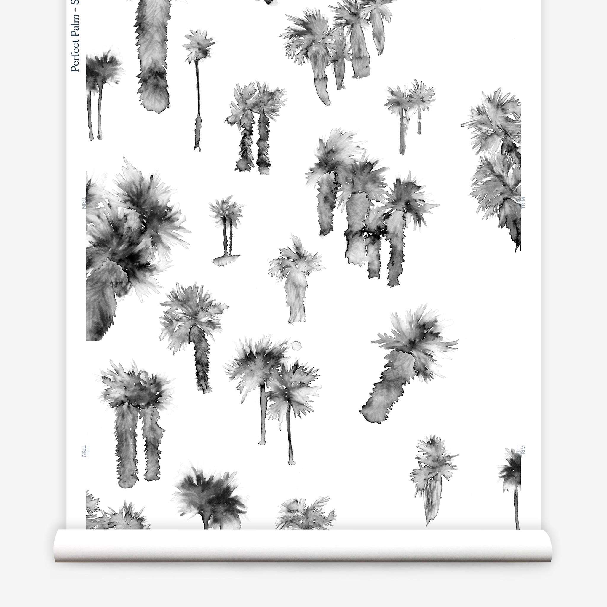 Partially unrolled wallpaper yardage in a playful palm tree print in shades of gray on a white field.