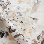 Floral patterned fabric with leaf and floral designs on a white background