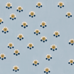 Detail of fabric in a minimal floral print in shades of gold, white and navy on a blue field.