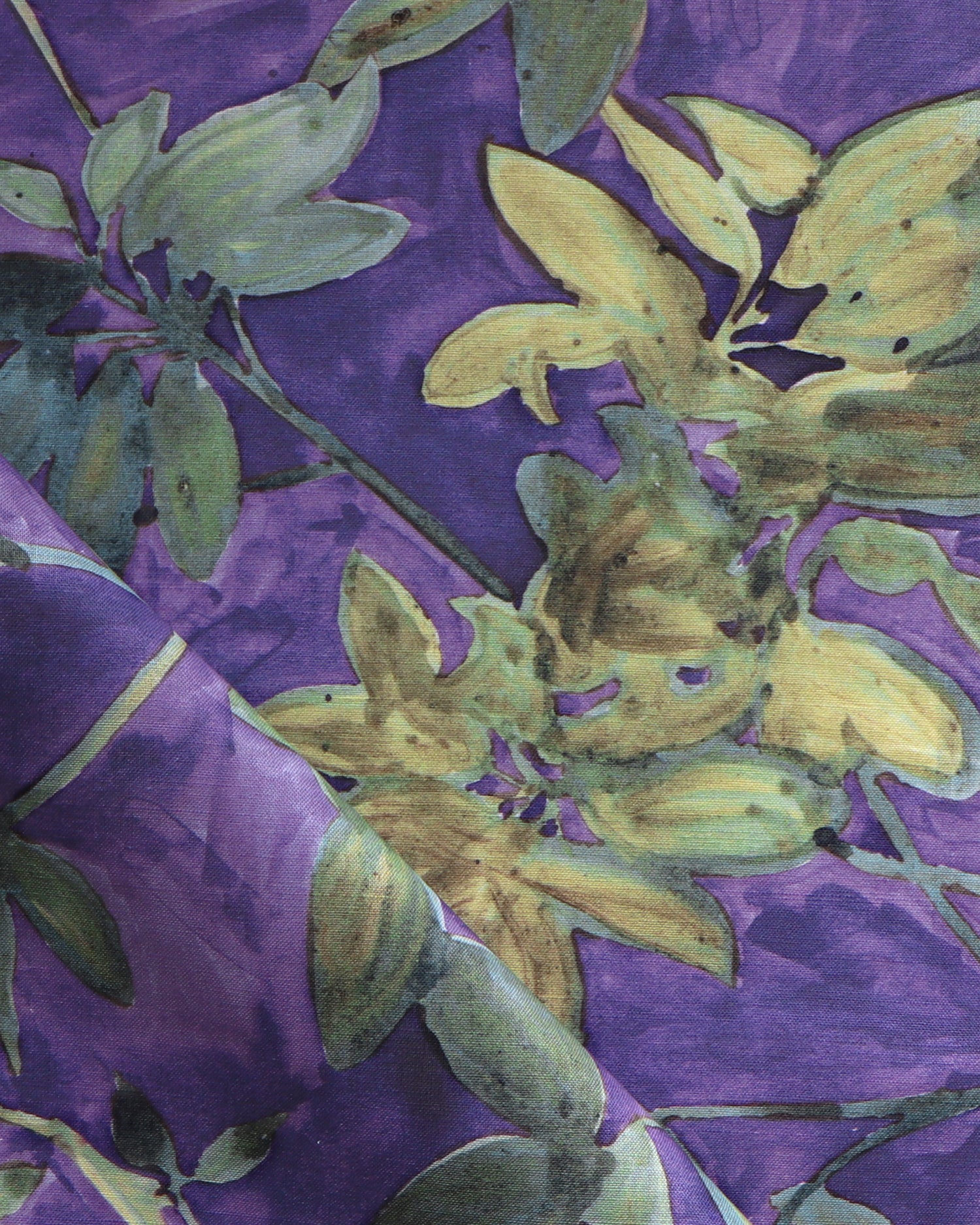 Fabric with floral pattern with green leaves on a purple background