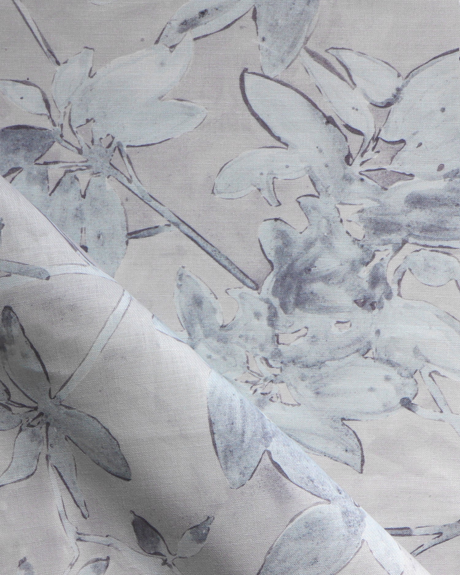 Close-up of floral patterned fabric with gray flowers on a beige background
