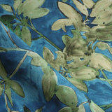 Close-up of a fabric with green floral pattern on blue background