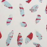 Detail of wallpaper in a playful paint blotch print in shades of red and blue on a cream field.