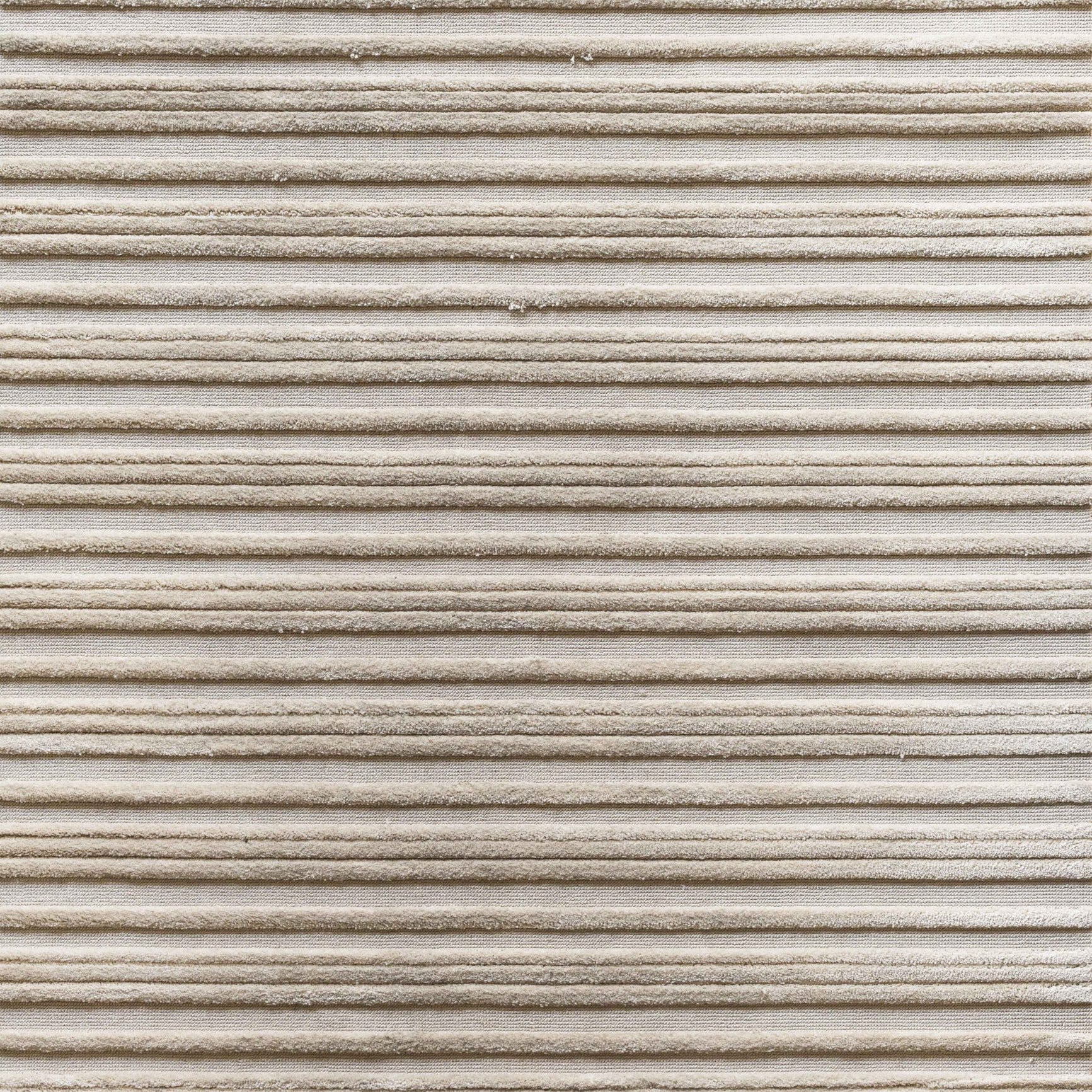 Textured carpet with horizontal loop and raised cut pile stripes in ivory.