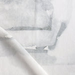 Draped fabric yardage in a watercolor watercolor print in shades of gray on a white field.