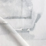 Draped fabric yardage in a watercolor watercolor print in shades of gray on a white field.