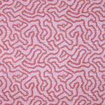 Printed fabric in a meandering hand drawn line pattern in red on a pink field. 