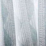 Close-up sheer linen fabric swatch in a horizontal stripe pattern broken with triangluar shapes, in shades of gray.