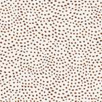 Detail of wallpaper in a scalloped dot print in rust on a cream field.