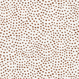 Detail of wallpaper in a scalloped dot print in rust on a cream field.