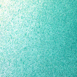 Close up of paint splatters in green and turquoise.